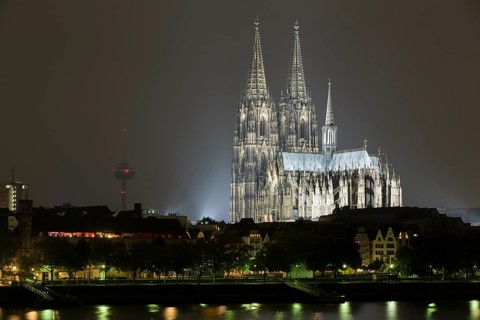 The Cologne Cathedral illuminated at night with Rhine