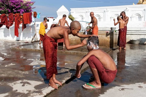Novice monks during the morning bath with a shaving of the head in the Shwe Yaunghwe Kyaung Monastery