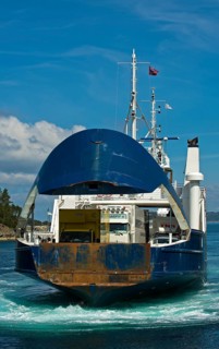 Ferry approaching the pier with an open bow section