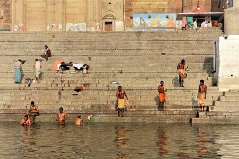 Devotees in ritual ablutions on the banks of the Ganges