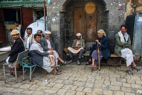 Men sitting in front of a house in the old city