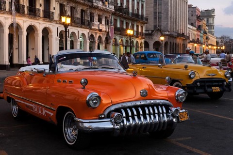 Vintage cars on the Prado at dusk