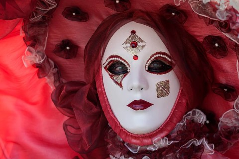 Venetian Carnival mask and costume at the Venetian Fair on the historic market square