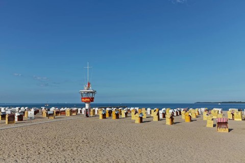Empty sandy beach with beach chairs and DLRG-lifeguard tower