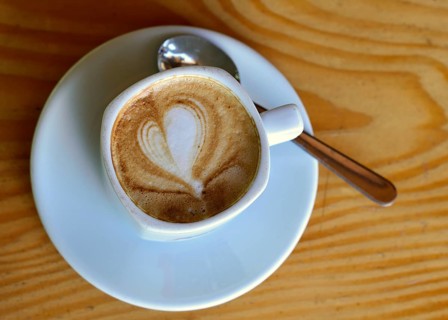 Cup of cappuccino with milk foam in a heart shape