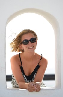 Young woman looking out from the Balcon de Femes