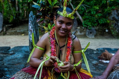 Traditionally dressed islander making traditional art work