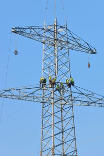 Overhead linemen working on a pylon