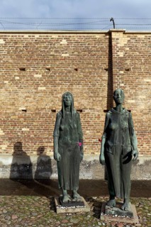 Sculptures of women in front of the Wall of Nations