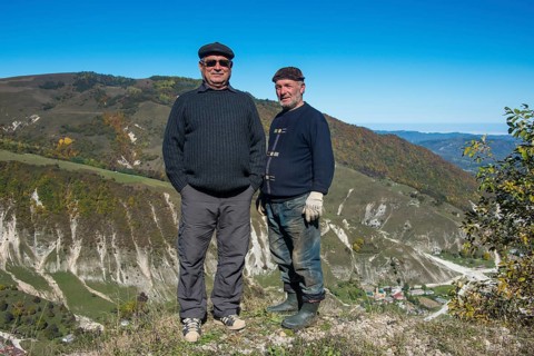 Old Chechen men at an overlook in the Chechen mountains