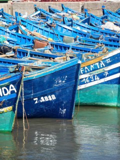 Old blue fishing boats in the port of Essaouira