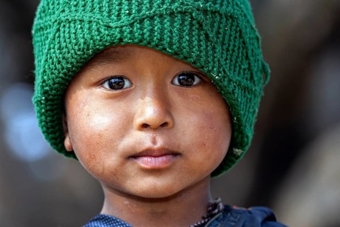 Nepalese boy with a green cap