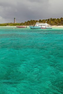 Boats off the island with a lighthouse