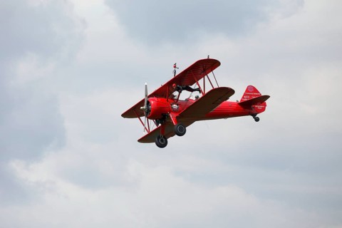 Wing walker on a biplane at an air show