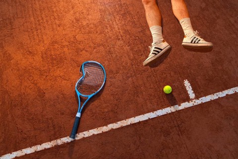 Tennis player lying on the ground