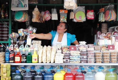 Woman selling sweets and drinks made from sugar cane