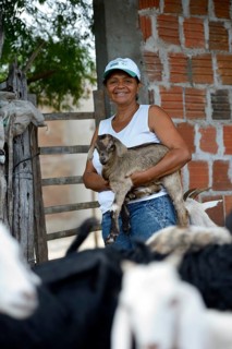 Woman holding a goatling