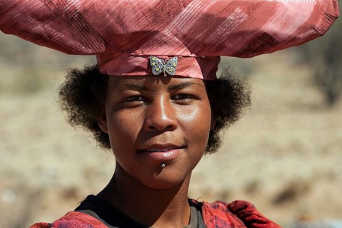 Native Herero woman with typical hat in Uis