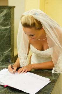 Bride signing the church register after the ceremony