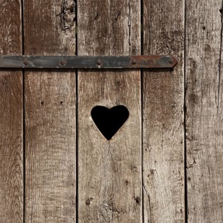 Weathered wooden door with a heart