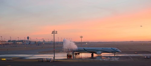 Aircraft de-icing at sunrise