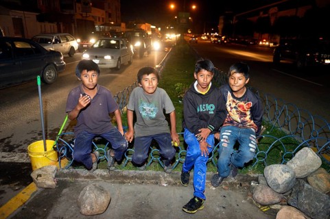 Group of street children on the roadside at night