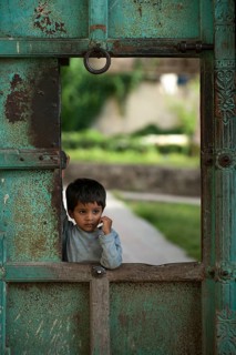 Little boy at a gate of the City Palace