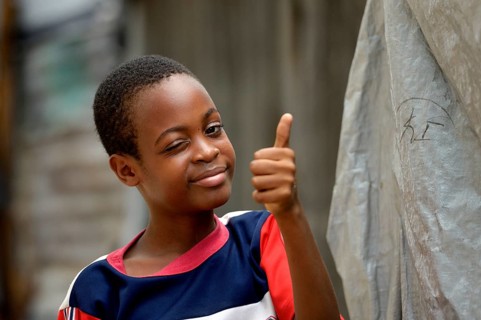 Young winking and giving his thumbs up
