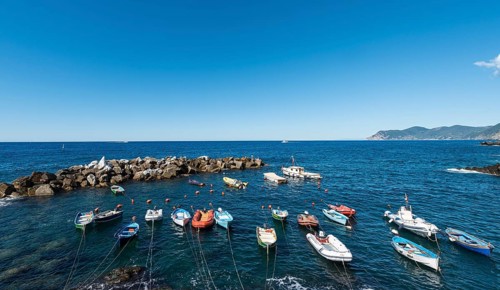 Boats in the harbor in front of harbour protection wall
