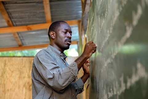 Teacher writing on the blackboard