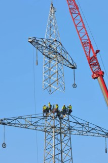 Overhead linemen working on a pylon