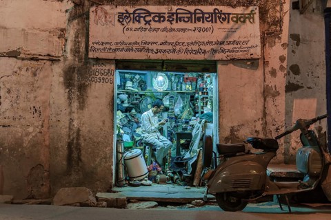 Electronics retailer in his workshop in the evening