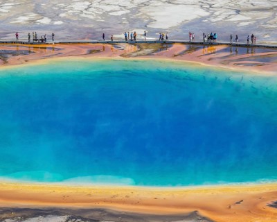 Tourists standing on the edge of Grand Prismatic Spring