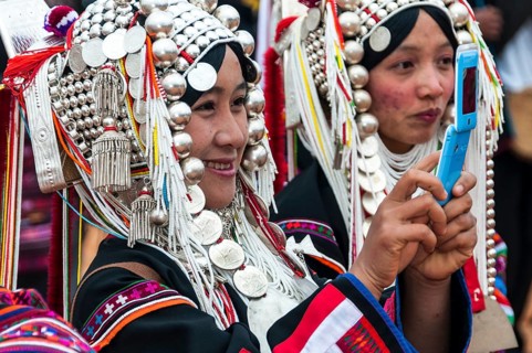 Traditionally dressed smiling young woman from the Akha people