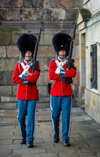 Royal Life Guards in red uniforms in front of Christiansborg Palace