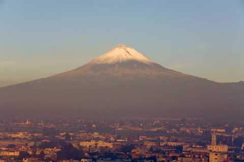 Popocatepetl volcano with the city of Cholula in early morning light