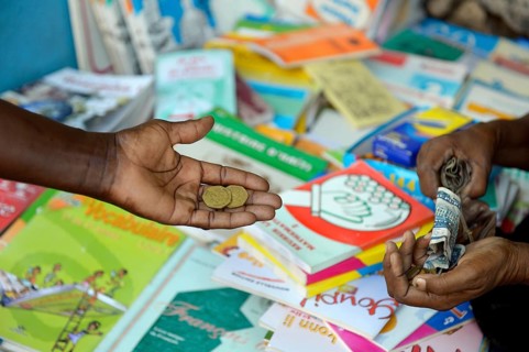 Mother buys school books on the market