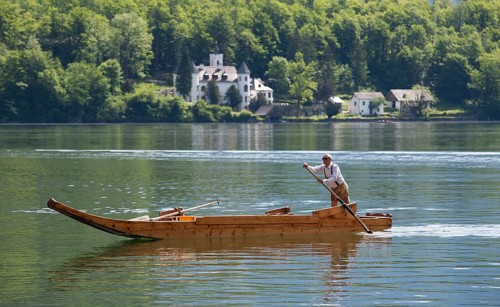 Barge with a rower on Lake Hallstatt or Hallstatter See lake