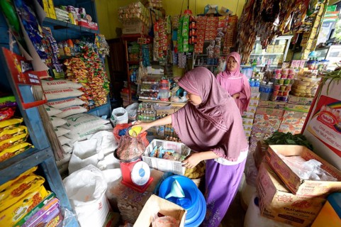 Young woman working in a small grocery store