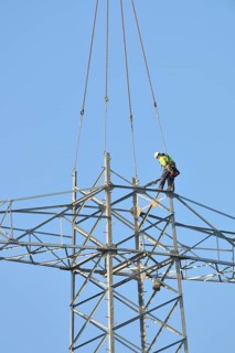 Overhead lineman working on a pylon