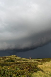 Dramatic storm clouds over dunes