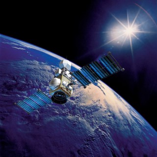 Satellite above the Earth pointed toward the rising sun