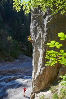 Sport climber climbing a rock face