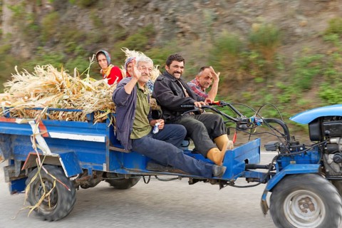 Farmers travelling on a tractor
