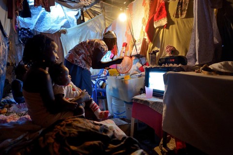 Woman and children in a ramshackle hut