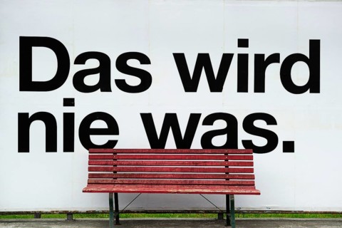 Bus stop that says ""Das wird nie was"" or ""that'll never work""