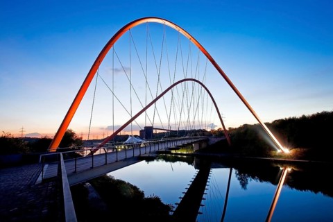 Illuminated double arch bridge over the Rhine-Herne Canal