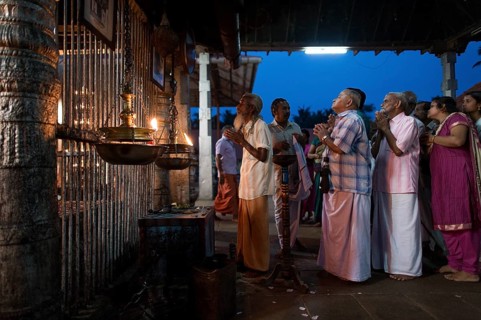 Hindus at evening prayer by the temple