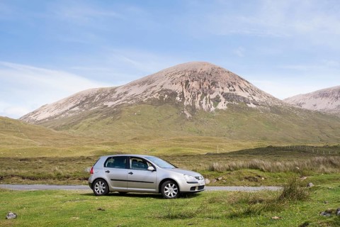 Volkswagen Golf car parked next to road with Beinn Dearg at the back