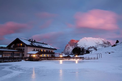 Sunset over Plattkofel and Mahlknechthutte hut in winter